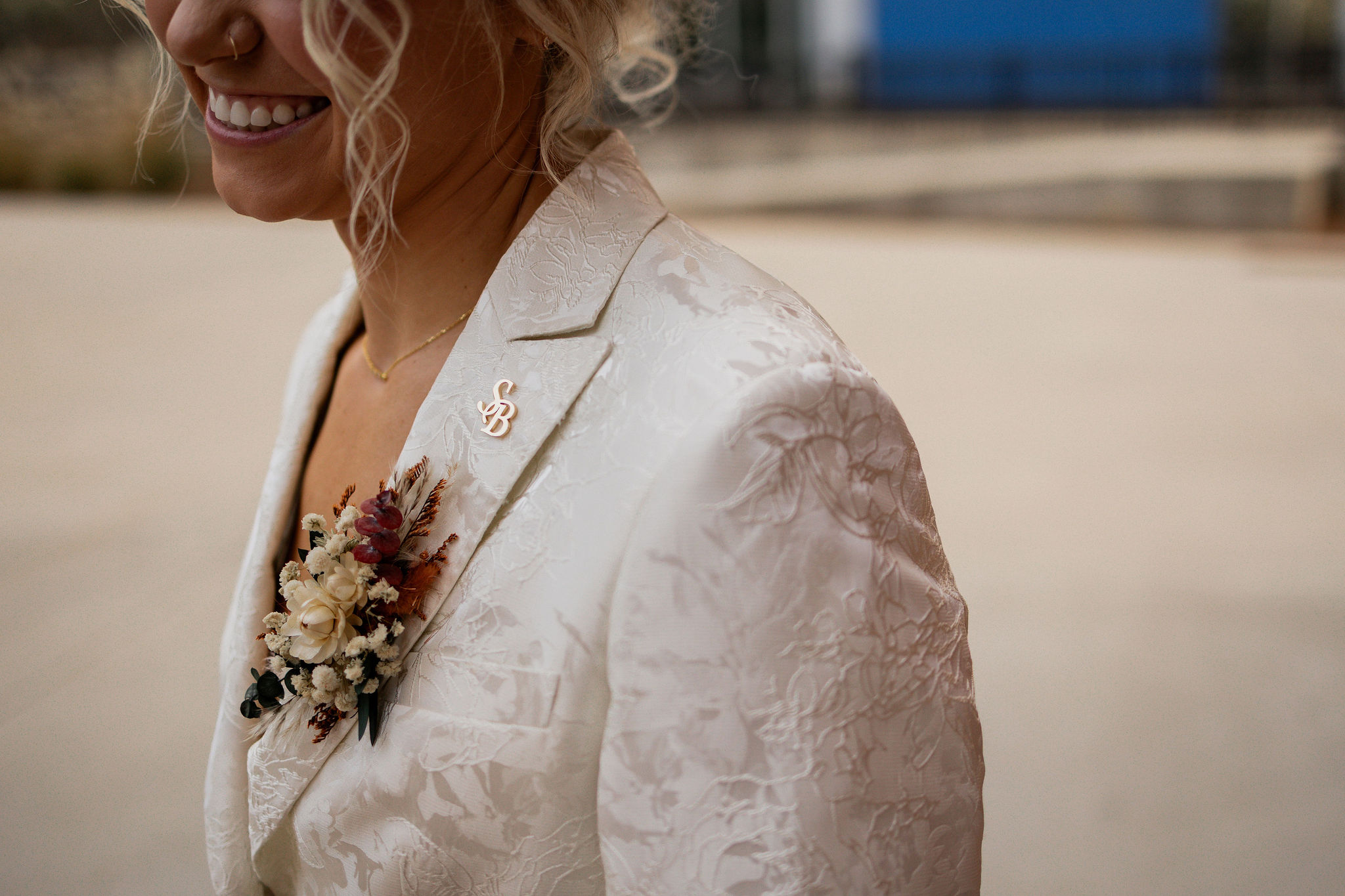 Close-up detail of textured white wedding suit fabric